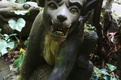 Ubud - Monkey Forest - Lion cub statue - Monkey on the back